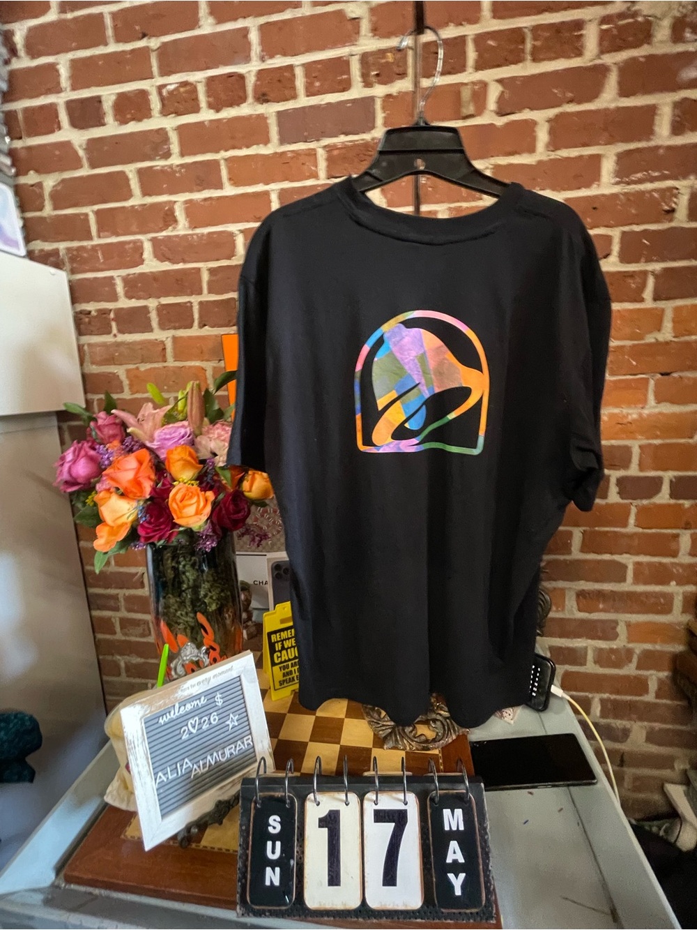Taco Bell t-shirt featuring a multicolored rainbow bell logo